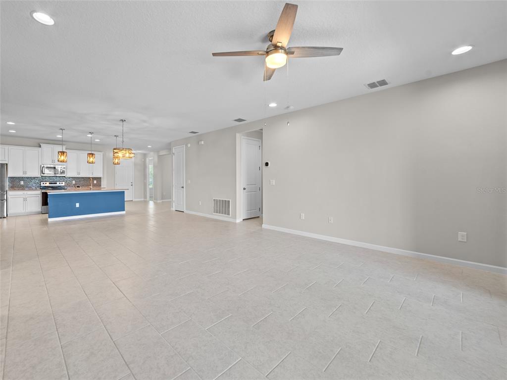 1010 Better Days Place Valrico, FL 33594 - Photo 26 of 55 an empty room with a kitchen and a ceiling fan window