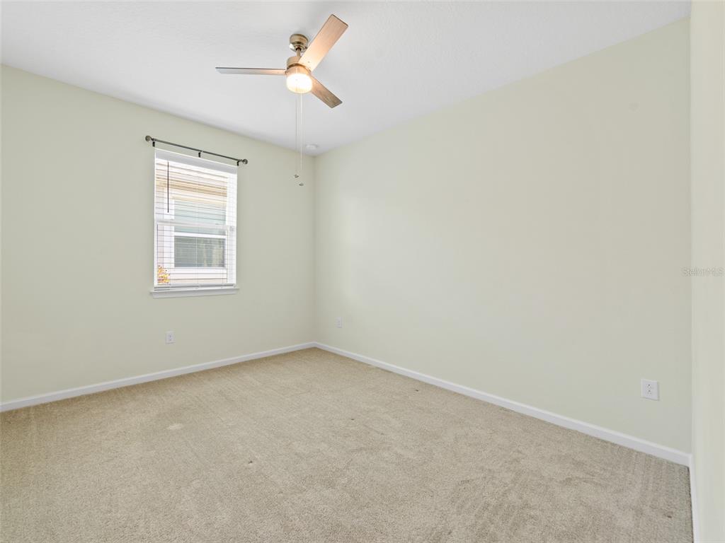 1010 Better Days Place Valrico, FL 33594 - Photo 36 of 55 an empty room with a window and a fan