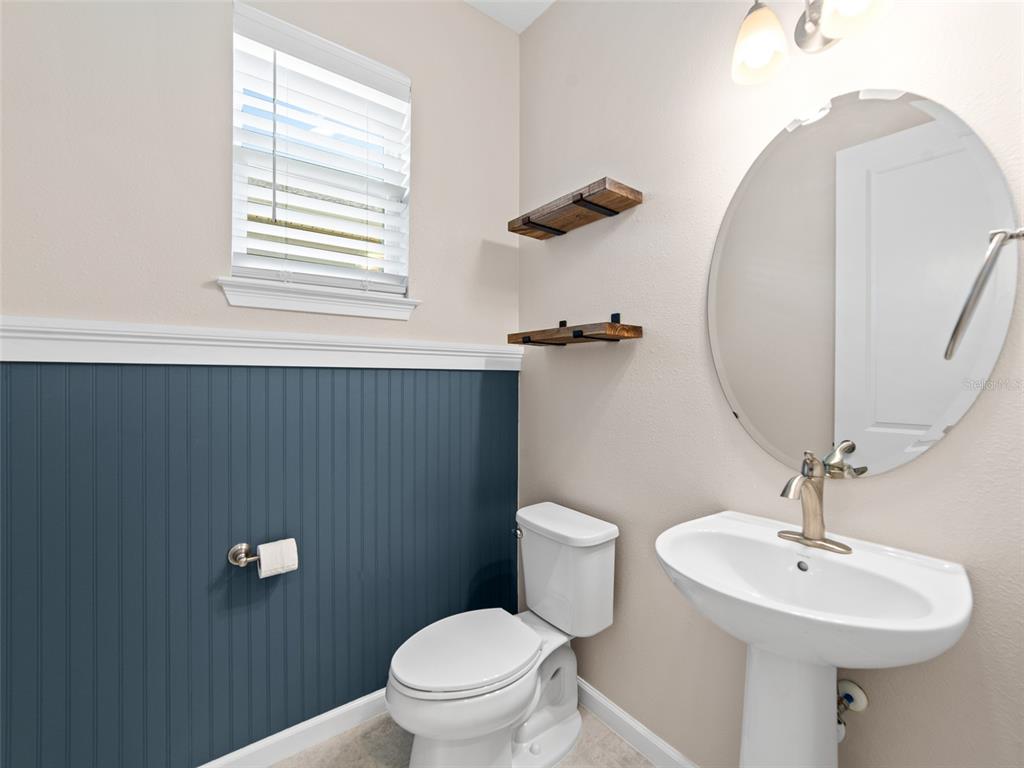 1010 Better Days Place Valrico, FL 33594 - Photo 40 of 55 a bathroom with a toilet a sink and mirror
