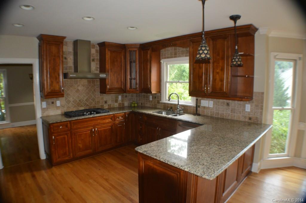 16336 Ranger Trail Huntersville, NC 28078 - Photo 2 of 12 a kitchen with granite countertop a sink a counter top space and cabinets