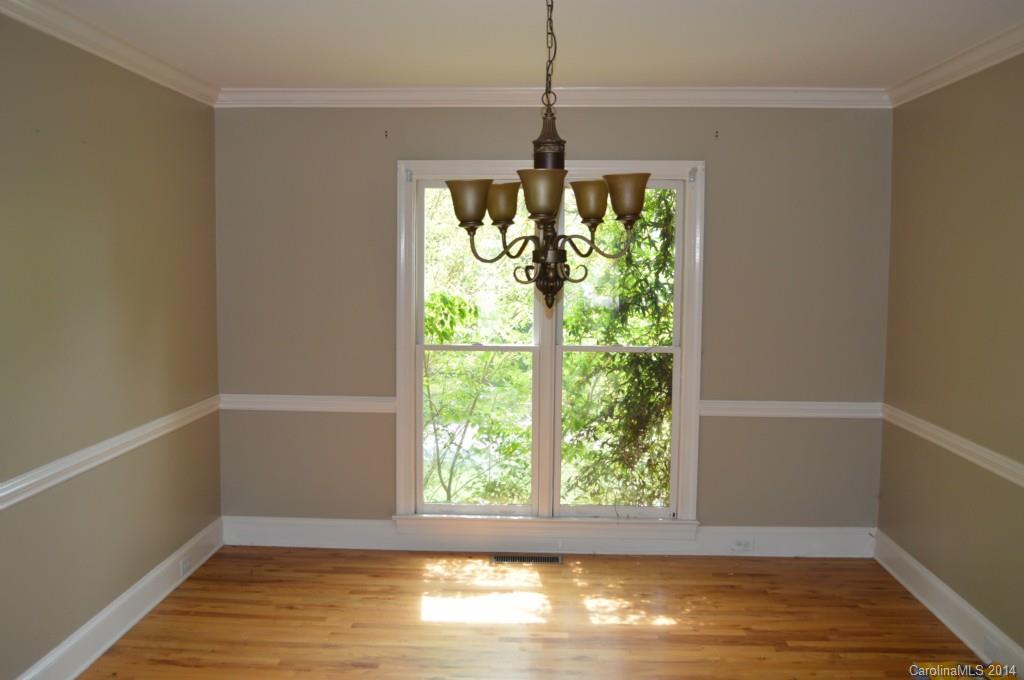 16336 Ranger Trail Huntersville, NC 28078 - Photo 4 of 12 a view of an empty room with wooden floor and a window