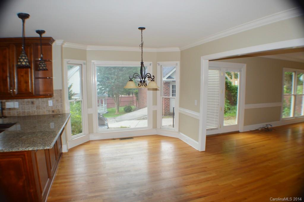 16336 Ranger Trail Huntersville, NC 28078 - Photo 6 of 12 a view of a living room with hardwood floor a ceiling fan and windows