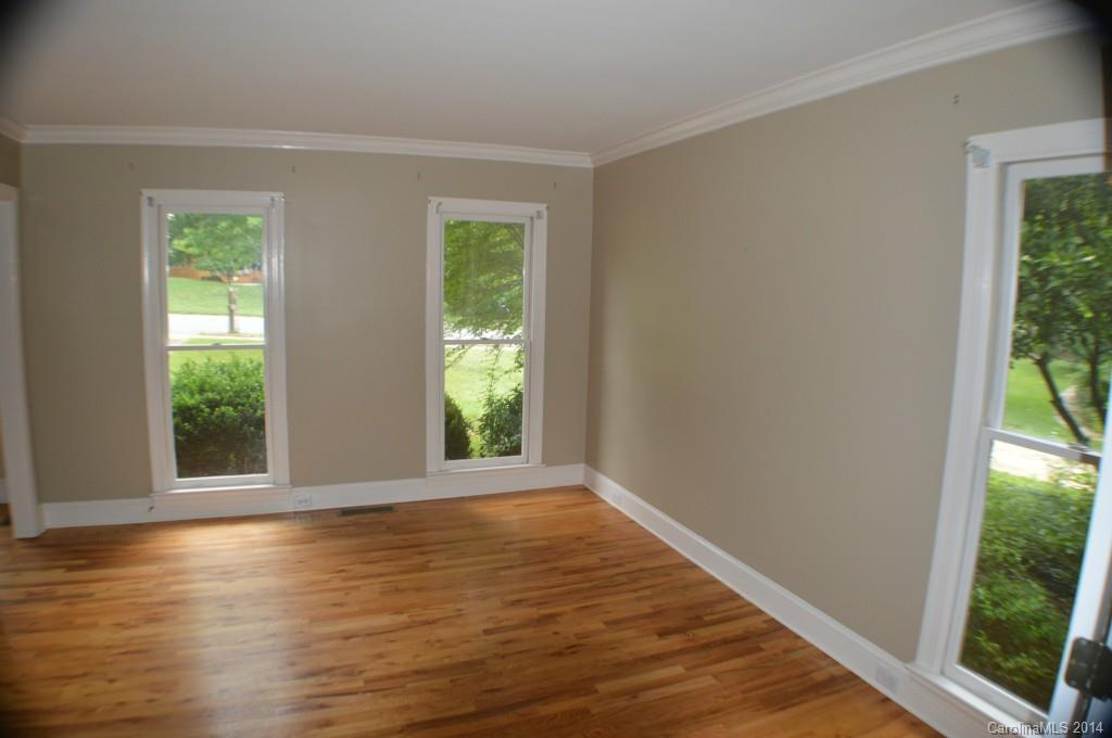16336 Ranger Trail Huntersville, NC 28078 - Photo 8 of 12 a view of an empty room with wooden floor and a window
