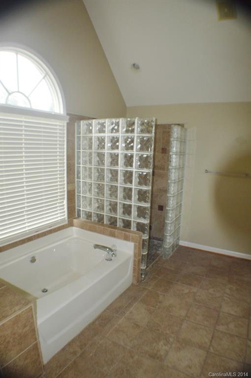 16336 Ranger Trail Huntersville, NC 28078 - Photo 10 of 12 a bathroom with a bathtub and a shower