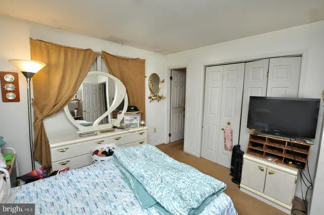 a bedroom with bed and flat screen tv