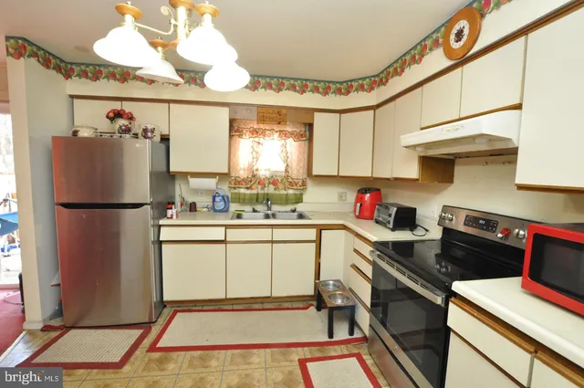 a kitchen with a refrigerator and a stove