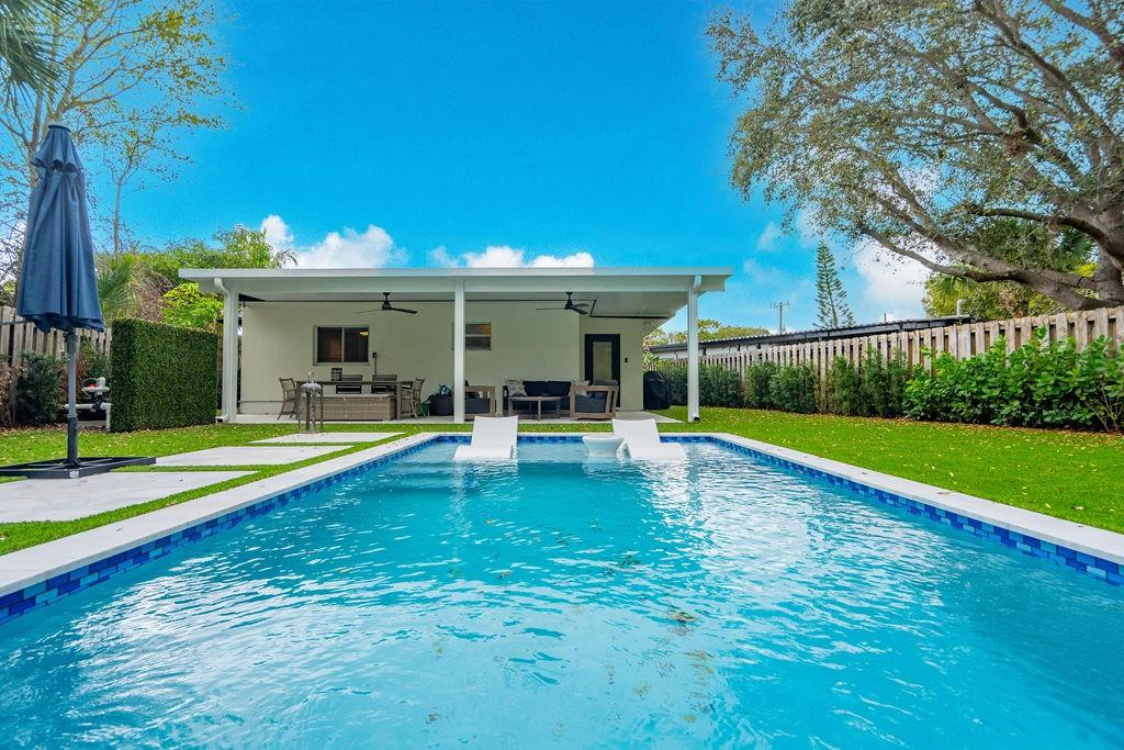 463 Newcastle Street Boca Raton, FL 33487 - Photo 23 of 32 a view of a house with swimming pool and a yard