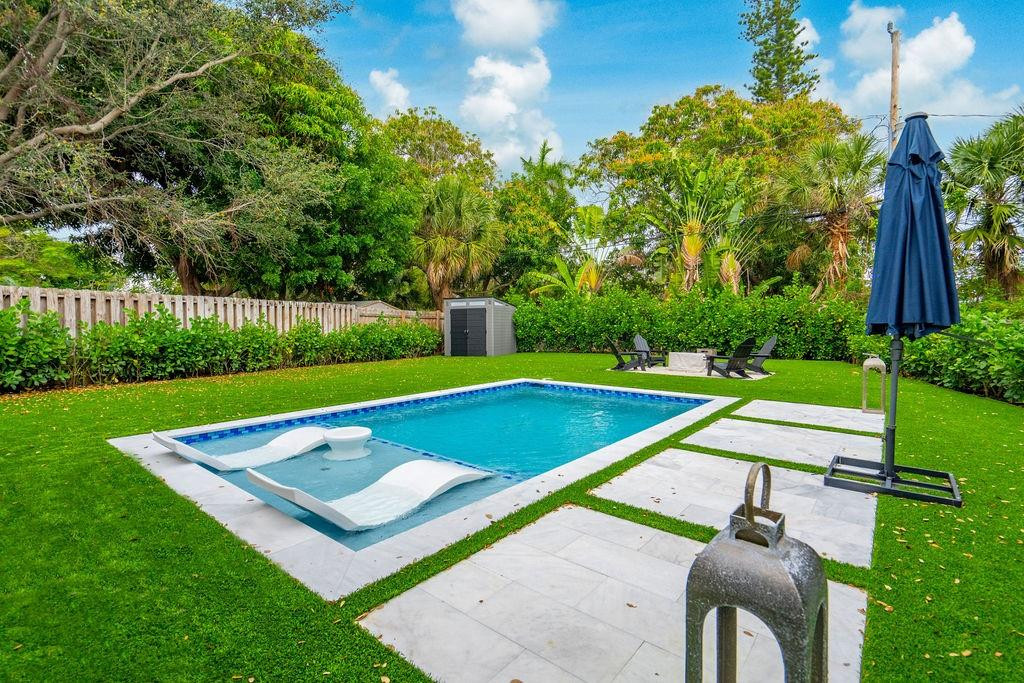 463 Newcastle Street Boca Raton, FL 33487 - Photo 27 of 32 a view of swimming pool with seating area and trees in the background