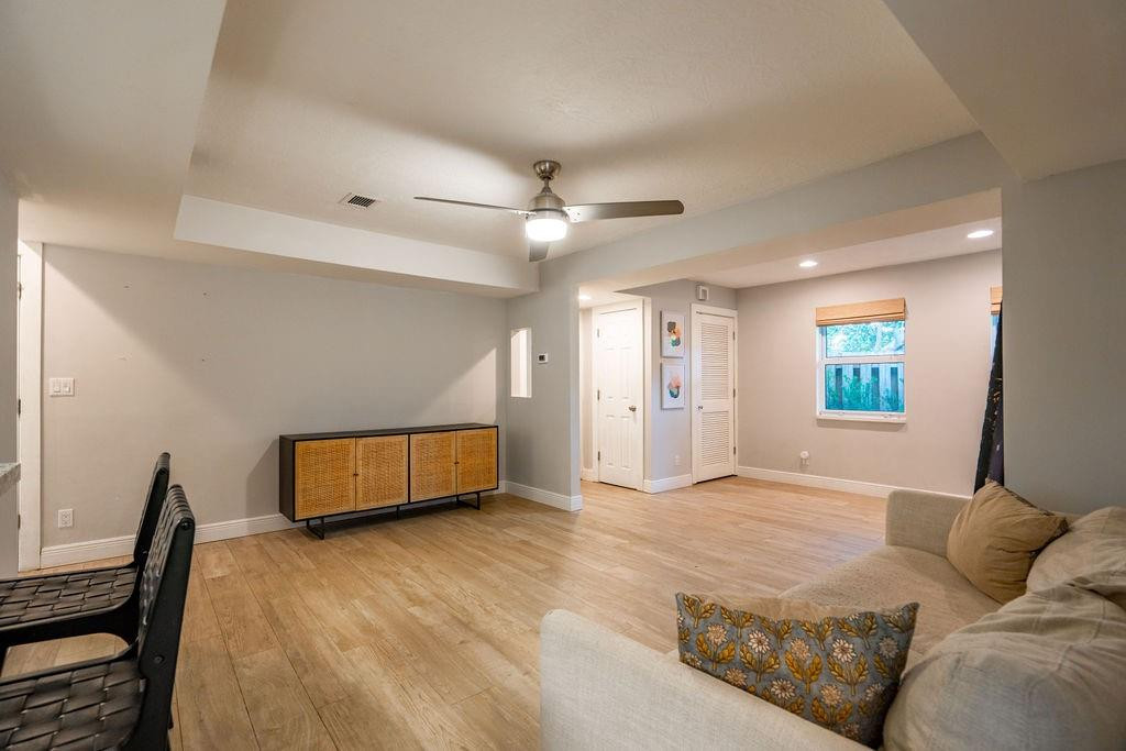 463 Newcastle Street Boca Raton, FL 33487 - Photo 7 of 32 a living room with a couch and a ceiling fan