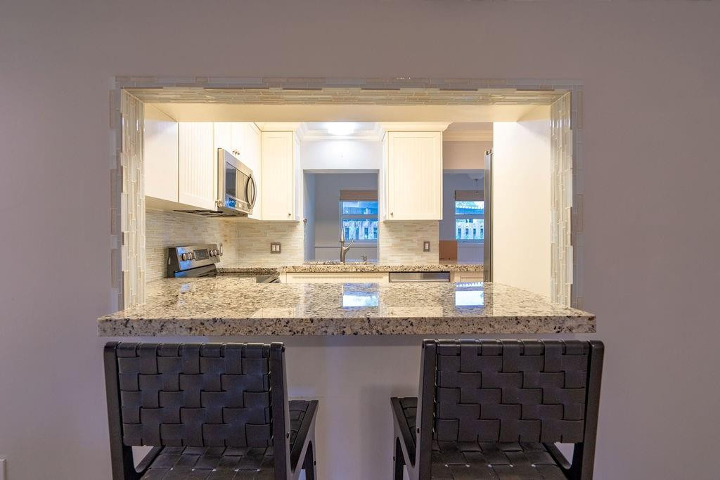 463 Newcastle Street Boca Raton, FL 33487 - Photo 9 of 32 a bathroom with a granite countertop sink and a large mirror