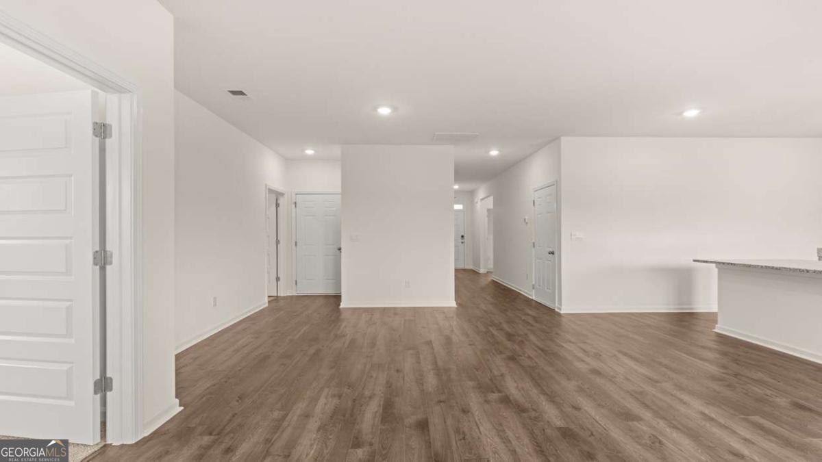8576 Seabiscuit Road Lithonia, GA 30058 - Photo 4 of 22 a view of an empty room with wooden floor