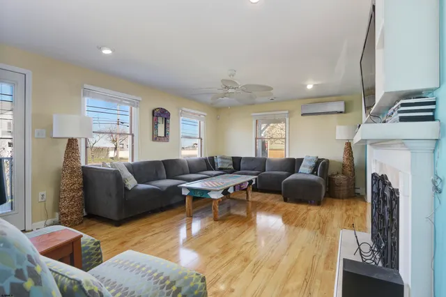 a living room with furniture a fireplace and a flat screen tv