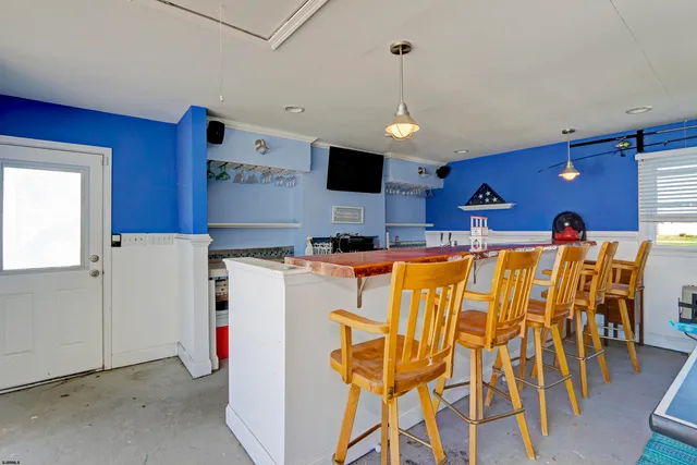 a kitchen with stainless steel appliances kitchen island granite countertop a refrigerator and a stove top oven