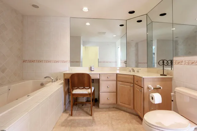 a bathroom with a granite countertop shower and a sink