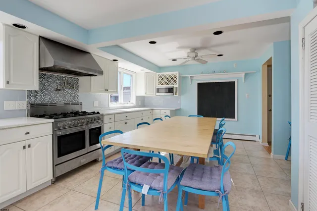 a kitchen with a dining table and chairs