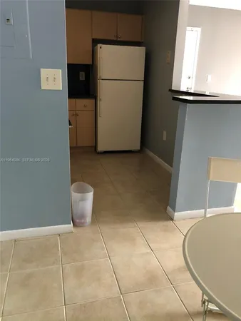 a view of an empty room with a floor to ceiling window