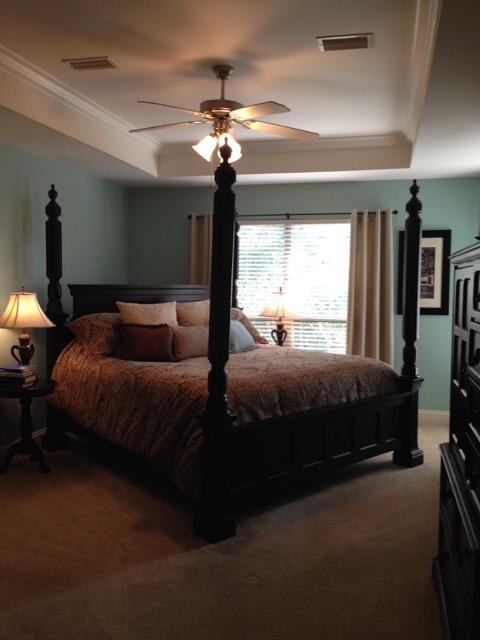 4556 Redbud Trail Niceville, FL 32578 - Photo 11 of 41 a bedroom with a bed and a chandelier
