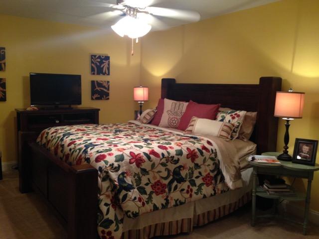 4556 Redbud Trail Niceville, FL 32578 - Photo 23 of 41 a bed sitting in a bedroom next to a lamp