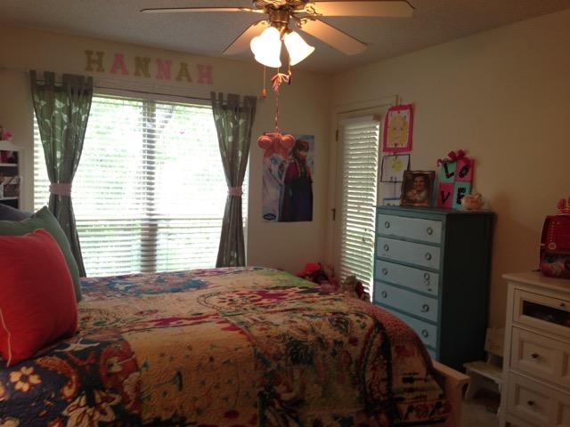 4556 Redbud Trail Niceville, FL 32578 - Photo 28 of 41 a bedroom with a bed and a chandelier