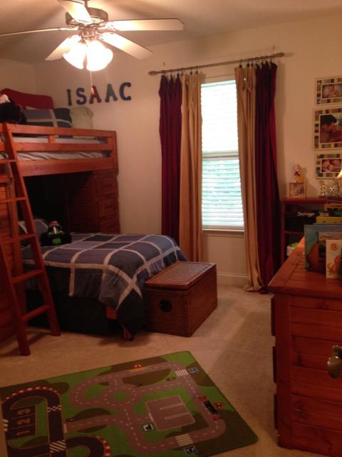 4556 Redbud Trail Niceville, FL 32578 - Photo 31 of 41 a bedroom with a bed and a chandelier