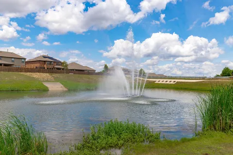 a view of a lake with a house in the background