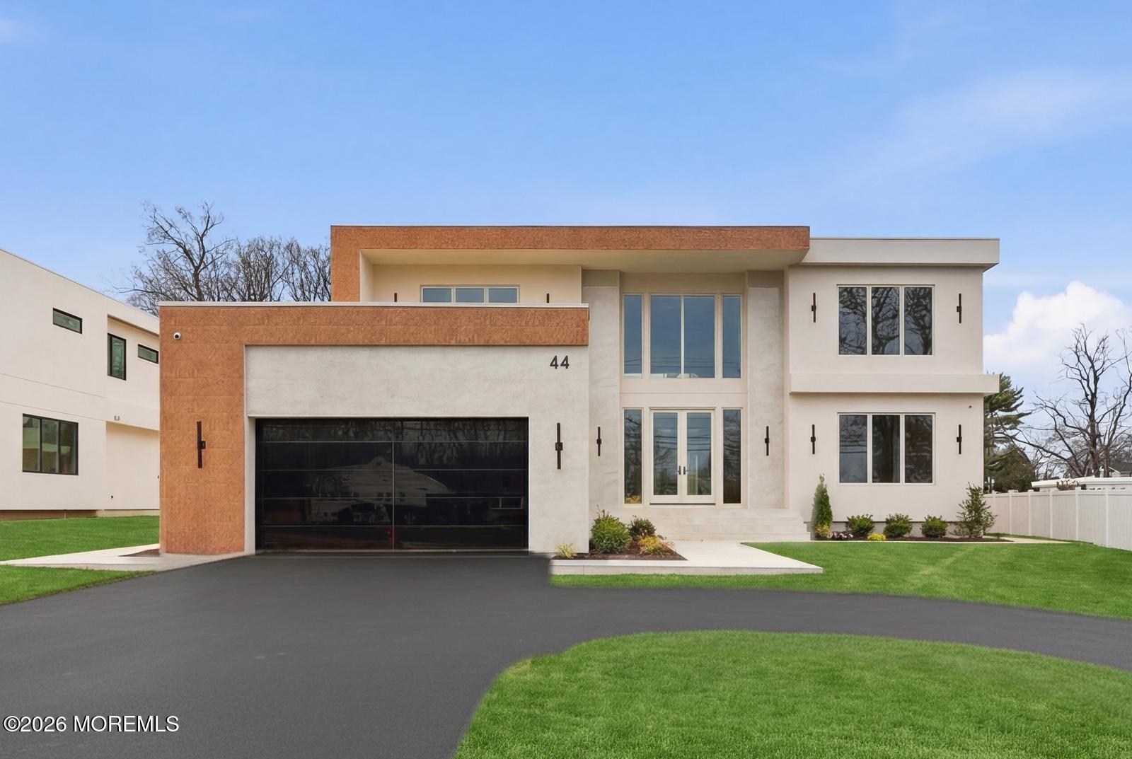 a front view of a house with a garden and yard