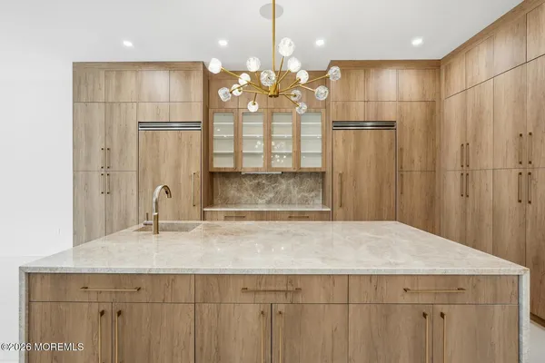 a bathroom with a granite countertop sink a large mirror and shower