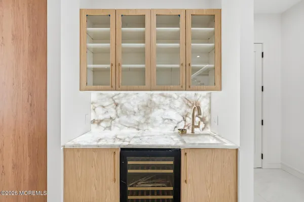 a bathroom with a granite countertop sink and a window