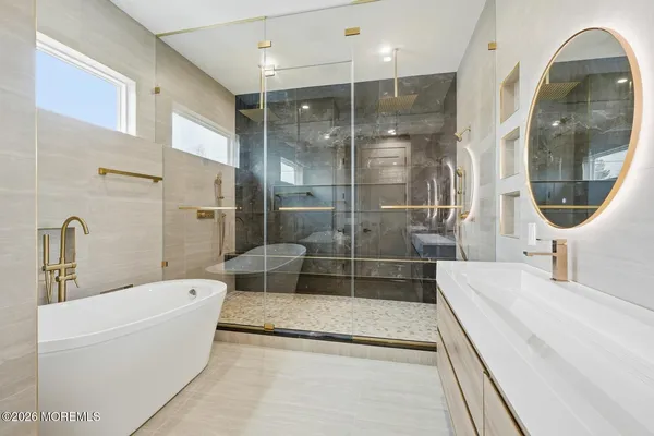 a bathroom with a bathtub and a mirror