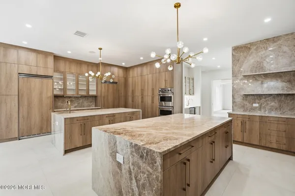 a kitchen with kitchen island a sink stainless steel appliances and cabinets