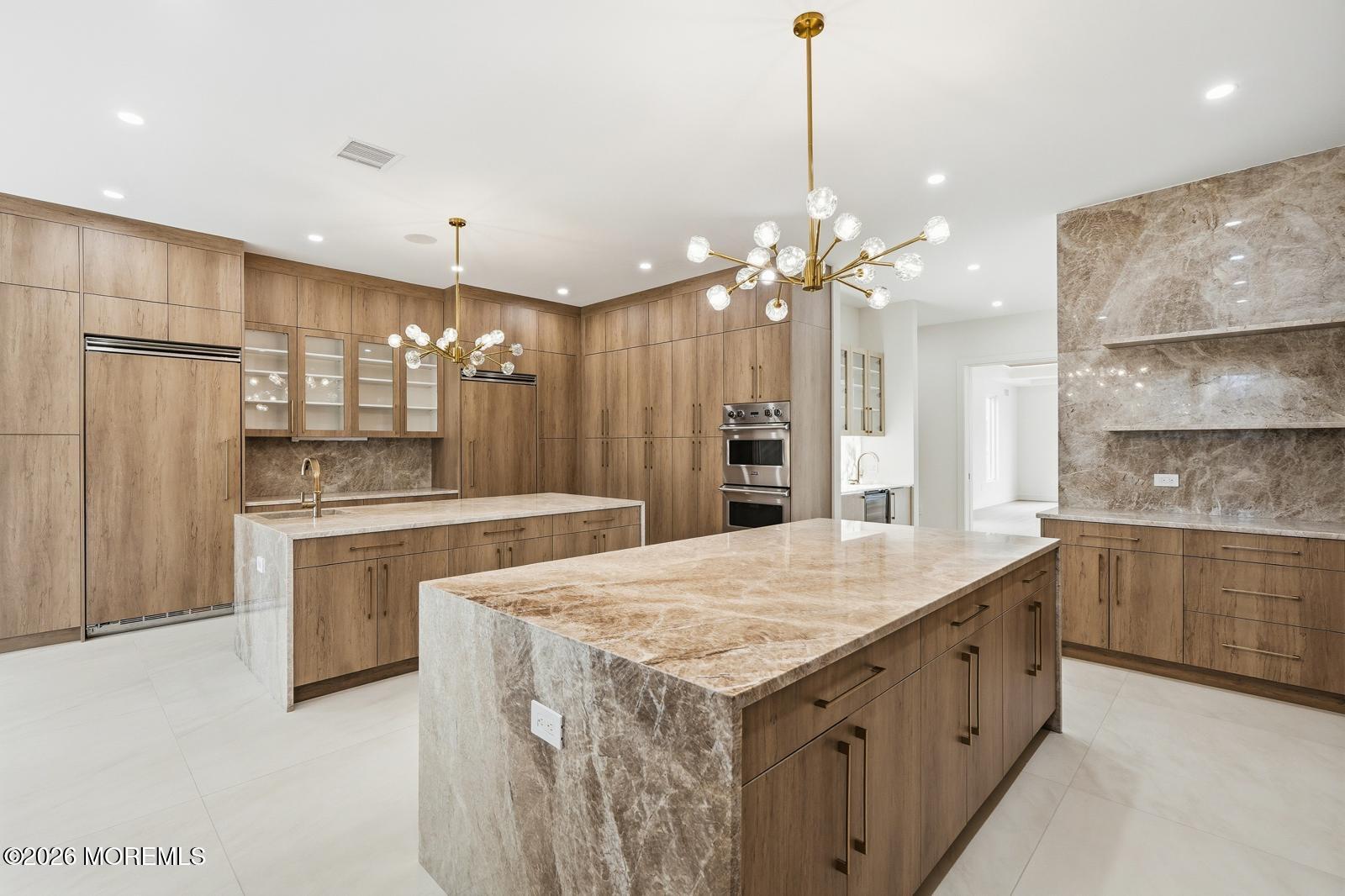 44 Whalepond Road Oakhurst, NJ 07755 - Photo 4 of 16 a kitchen with kitchen island a sink stainless steel appliances and cabinets