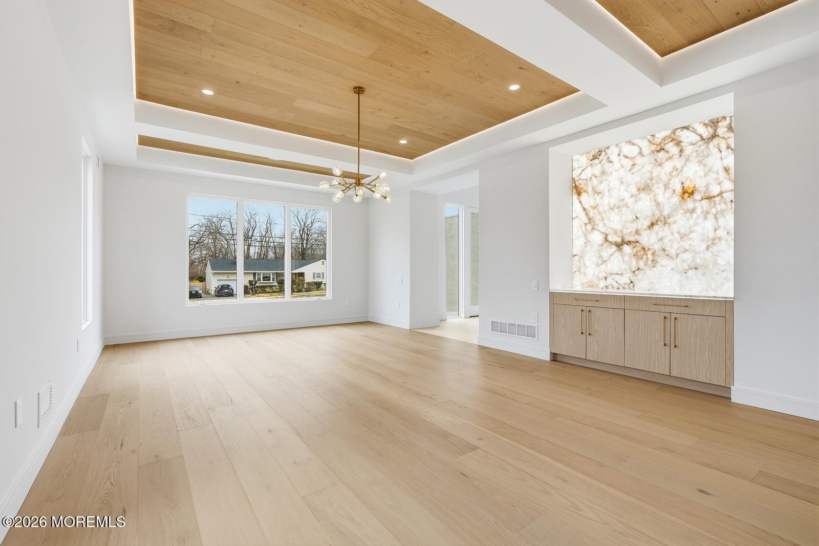 44 Whalepond Road Oakhurst, NJ 07755 - Photo 7 of 16 a view of an empty room with a window and chandelier fan