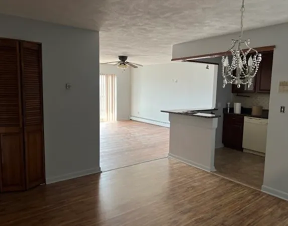 a view of a refrigerator and wooden floor
