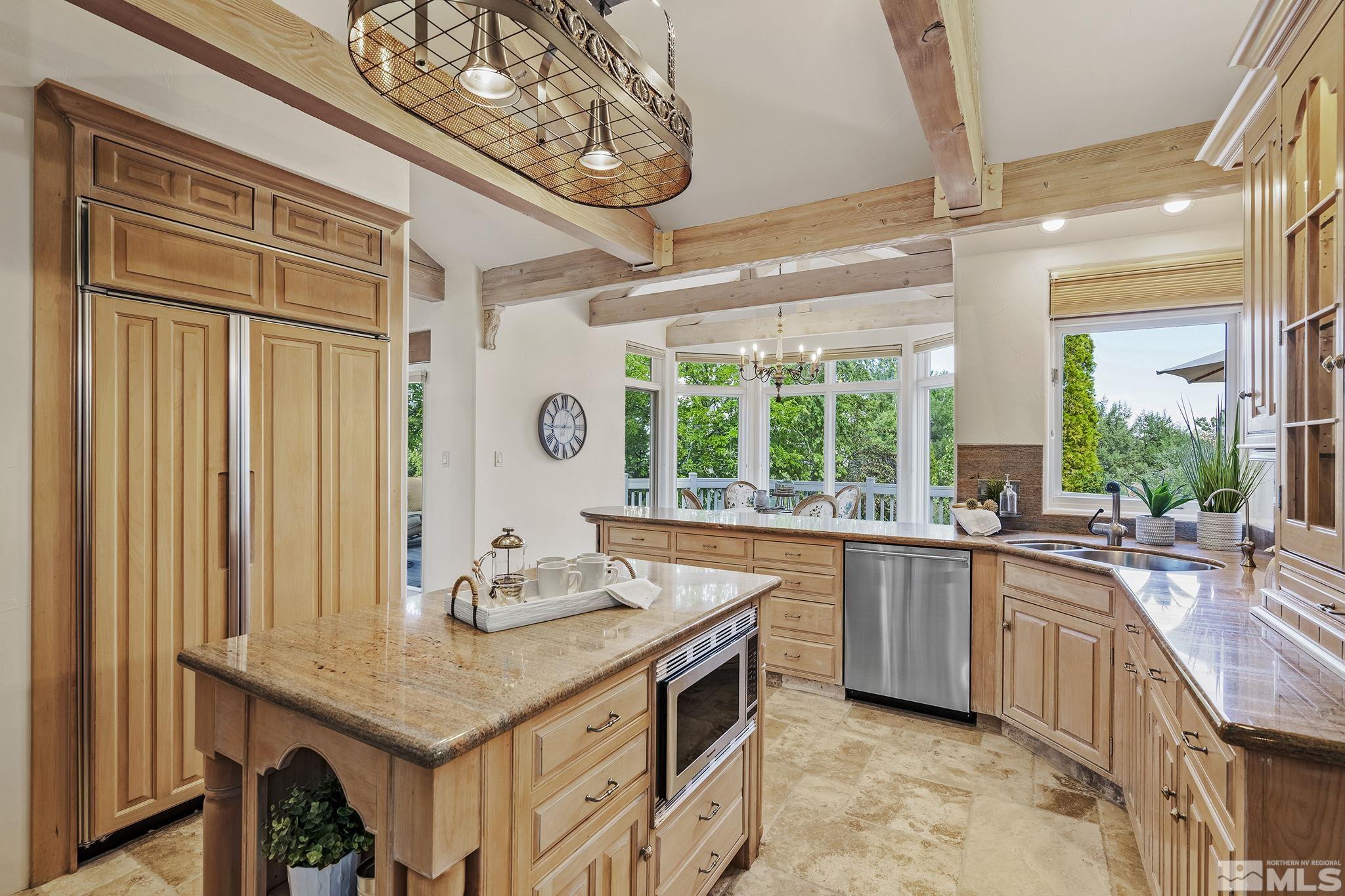 15 Promontory Pointe Reno, NV 89519 - Photo 14 of 40 a kitchen with stainless steel appliances granite countertop a sink stove and cabinets