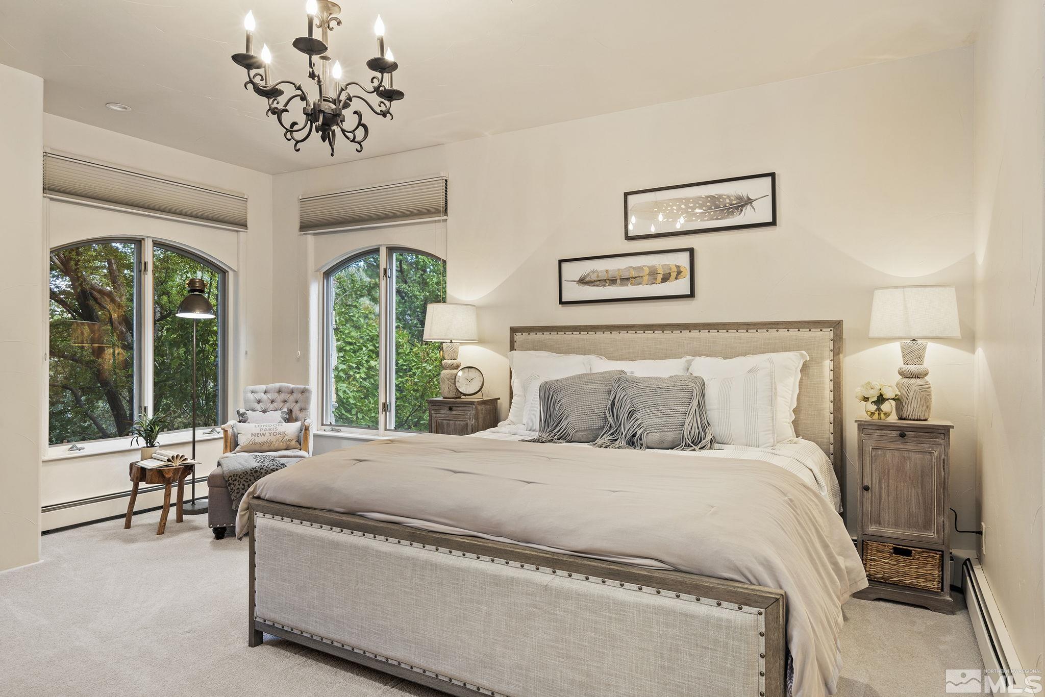 15 Promontory Pointe Reno, NV 89519 - Photo 17 of 40 a bedroom with a large bed and a chandelier