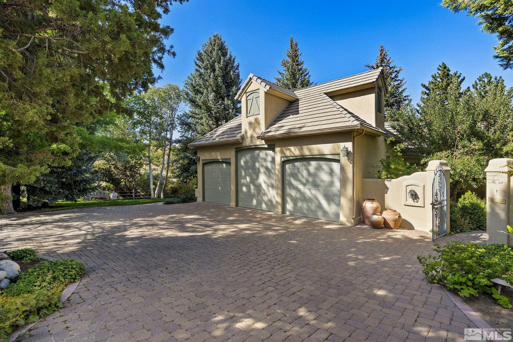 15 Promontory Pointe Reno, NV 89519 - Photo 2 of 40 a front view of a house with a yard and garage