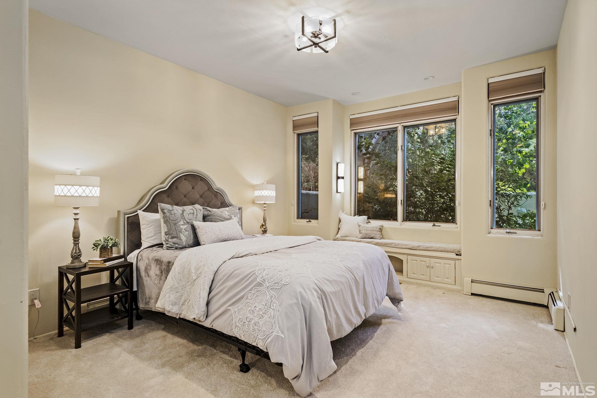 15 Promontory Pointe Reno, NV 89519 - Photo 22 of 40 a bedroom with a large bed and a large window