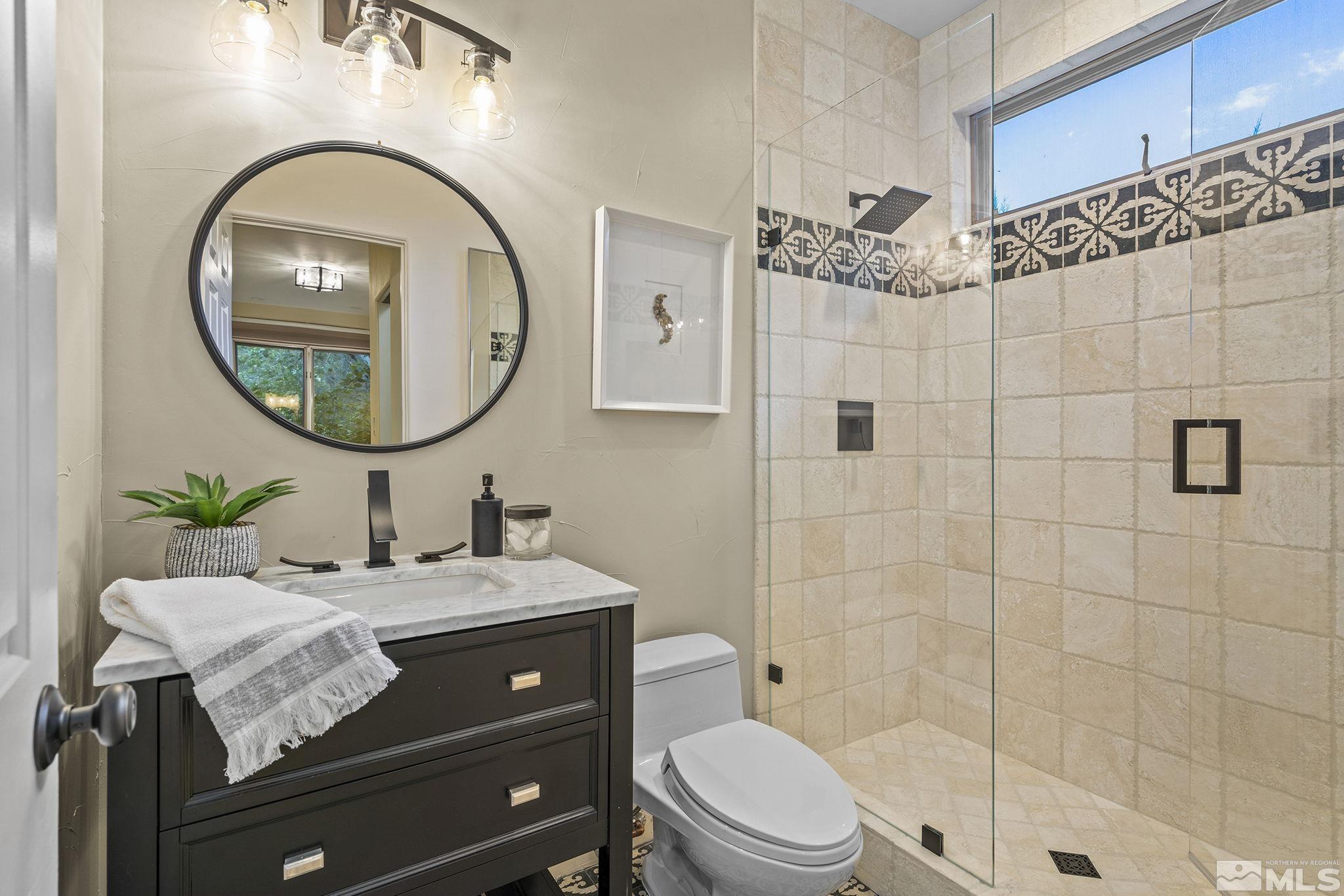 15 Promontory Pointe Reno, NV 89519 - Photo 23 of 40 a bathroom with a sink a mirror and a toilet
