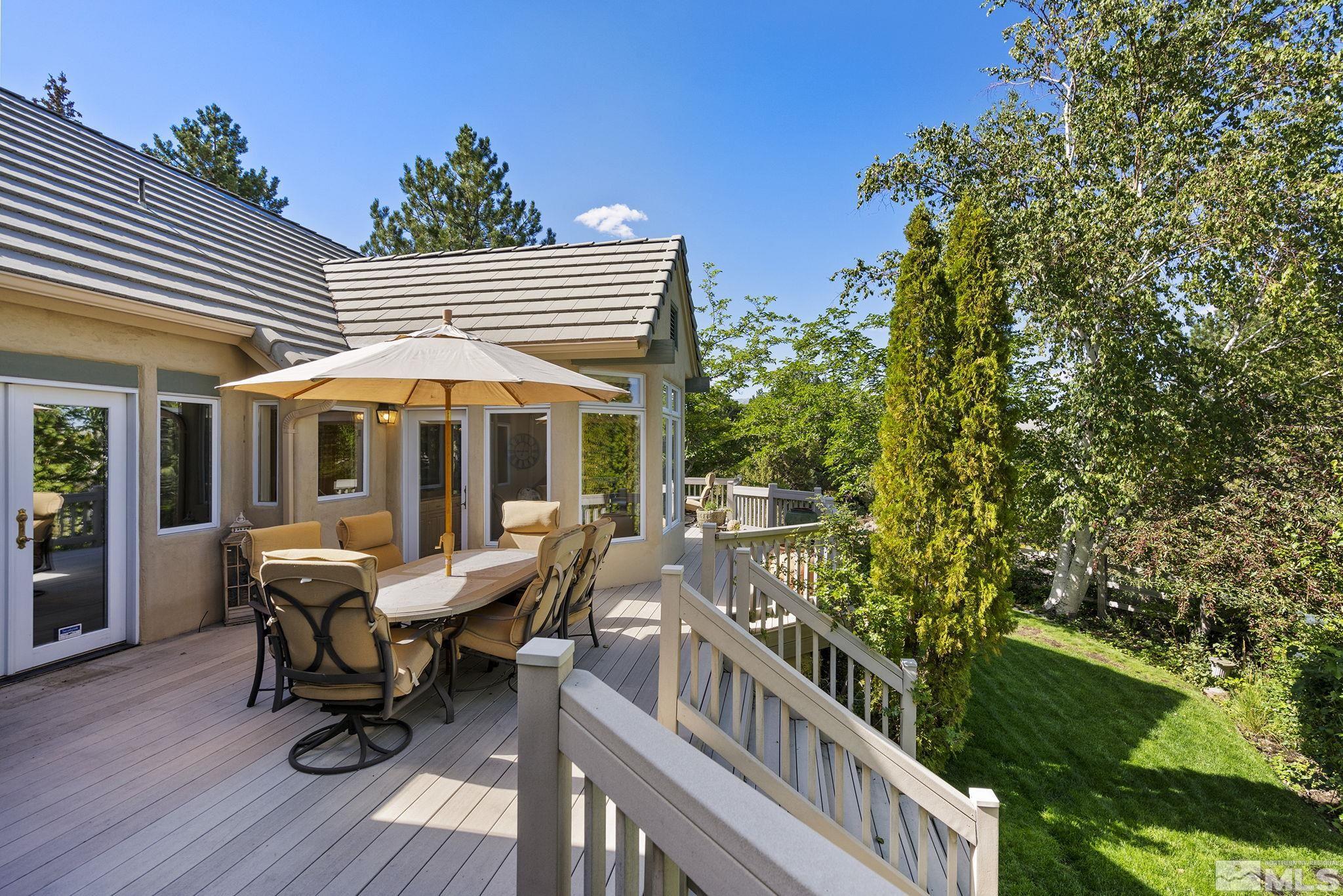 15 Promontory Pointe Reno, NV 89519 - Photo 32 of 40 a view of a deck with table and chairs with wooden floor and fence