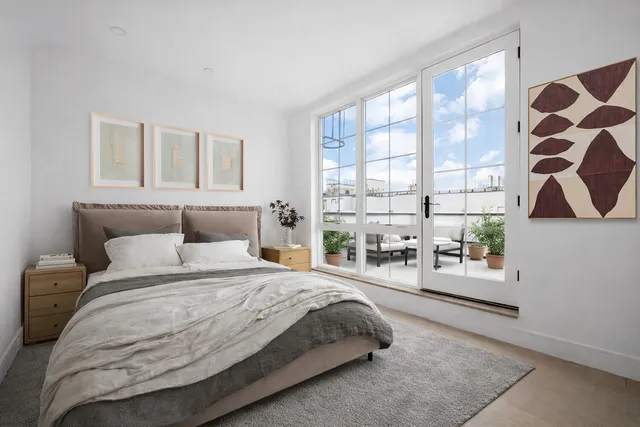 a view of a room with wooden floor and windows