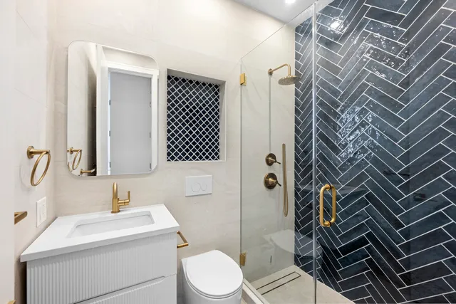 a bedroom with a bed lamp and a large window