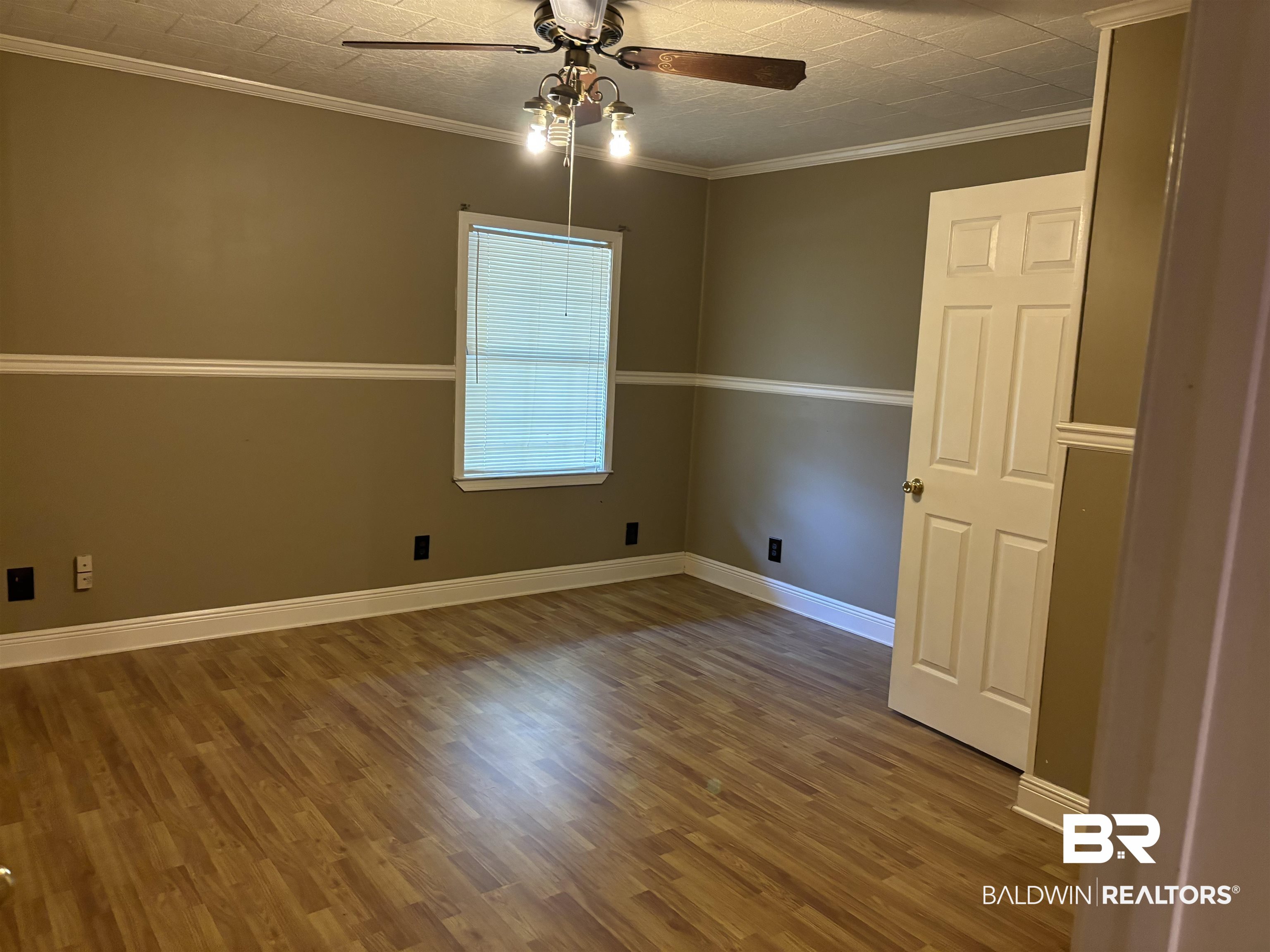 17495 County Road 48 Robertsdale, AL 36567 - Photo 33 of 37 Empty room featuring ornamental molding, hardwood / wood-style floors, and ceiling fan
