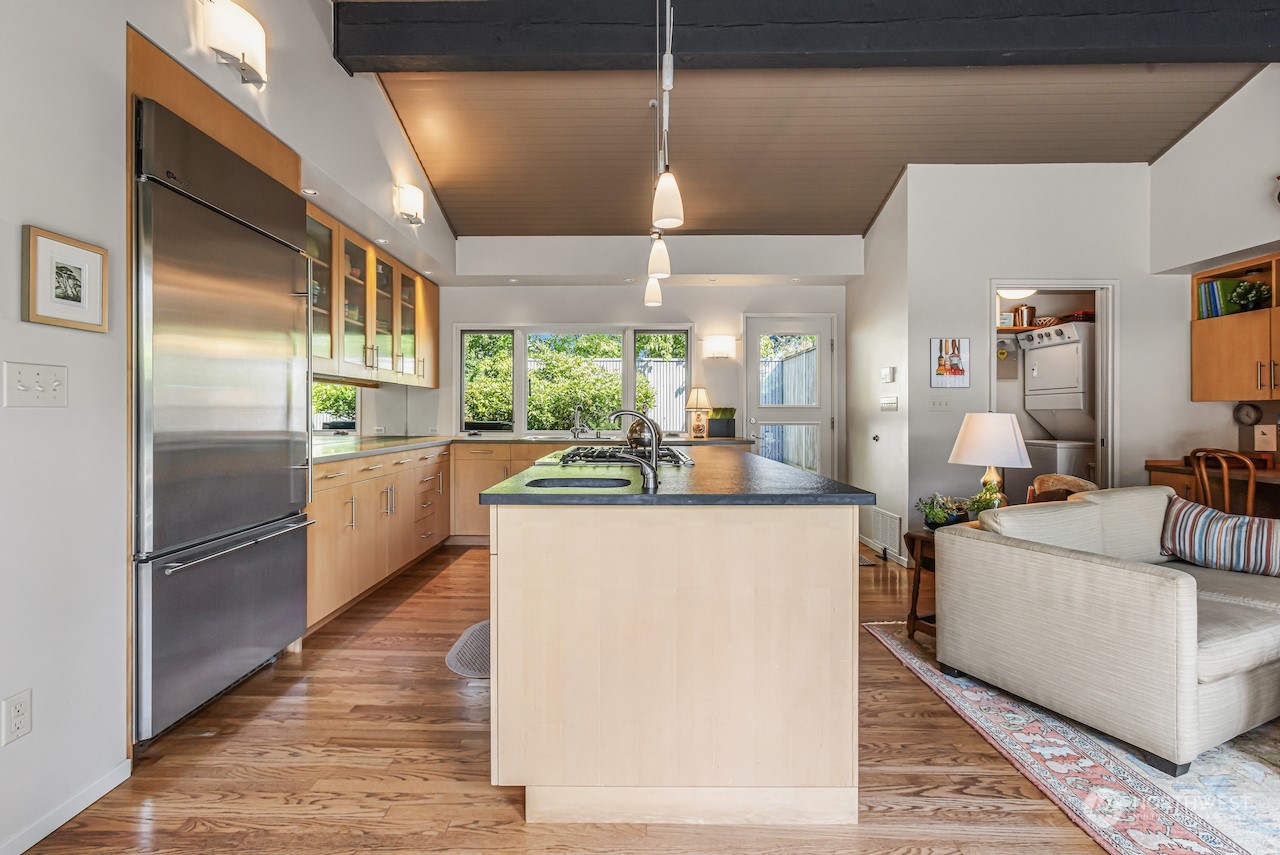 234 Middlefield Road Bellingham, WA 98225 - Photo 14 of 36 a kitchen with stainless steel appliances kitchen island granite countertop a refrigerator a stove and a sink with wooden floor