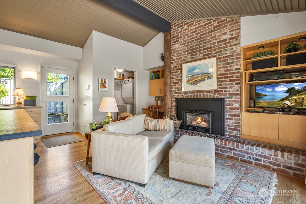 234 Middlefield Road Bellingham, WA 98225 - Photo 17 of 36 a living room with furniture a flat screen tv and a fireplace