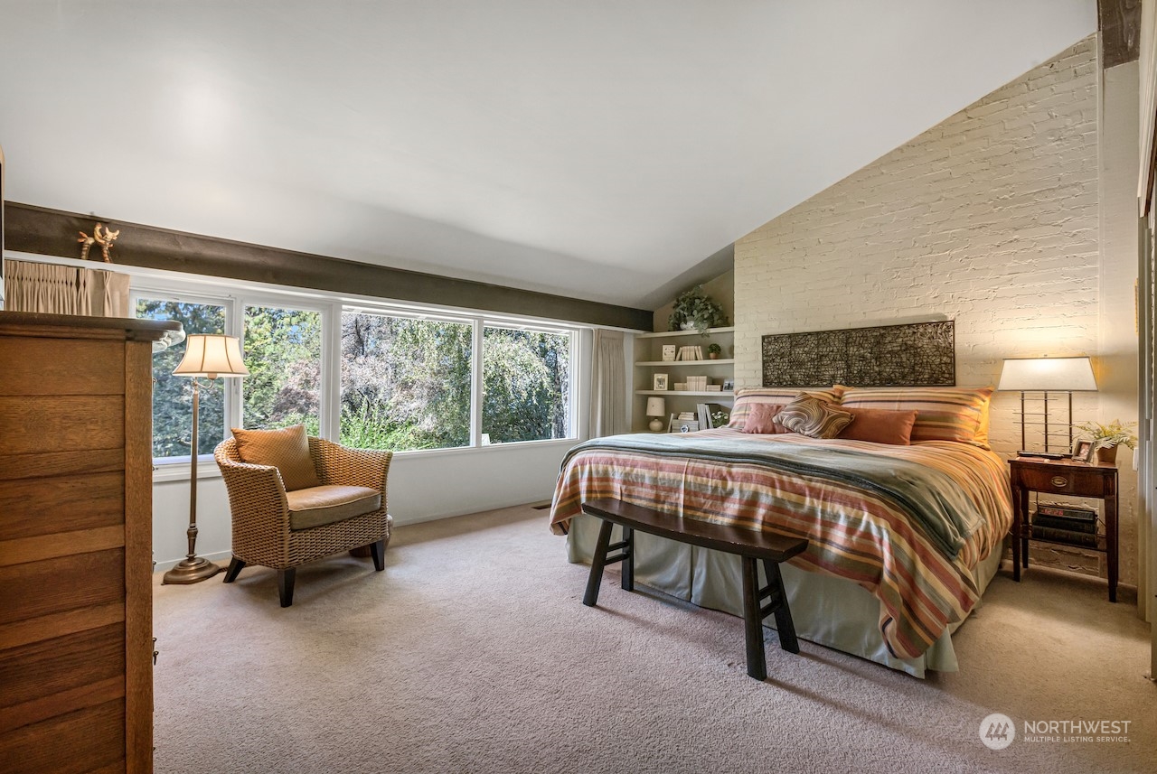 234 Middlefield Road Bellingham, WA 98225 - Photo 21 of 36 a bedroom with a bed and a couch with large window