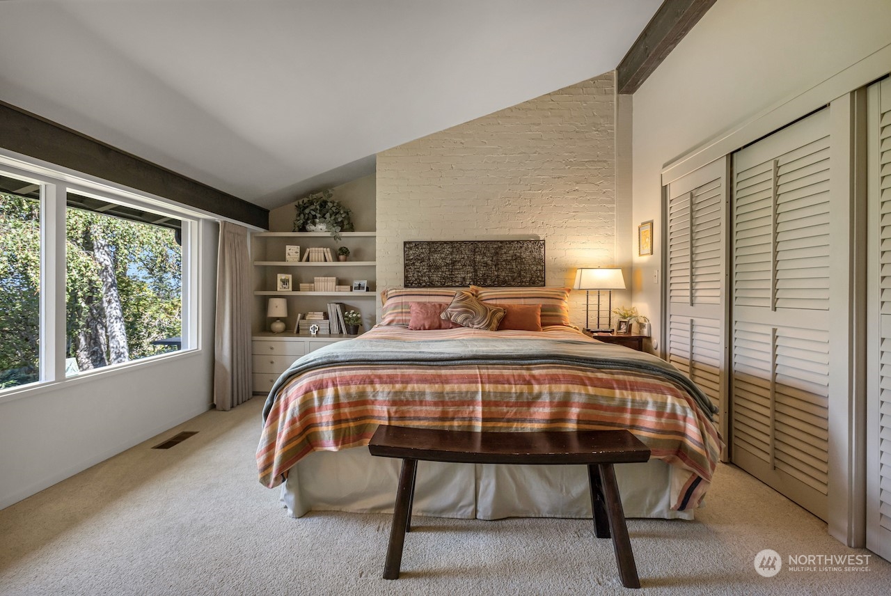 234 Middlefield Road Bellingham, WA 98225 - Photo 22 of 36 a bed sitting in a bedroom next to a window