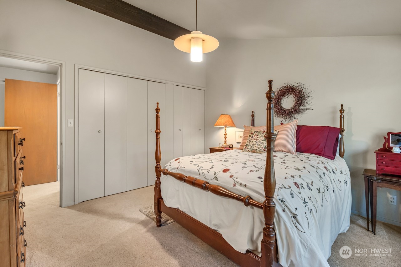 234 Middlefield Road Bellingham, WA 98225 - Photo 27 of 36 a bedroom with a bed and a chandelier