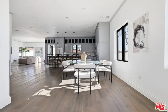 a living room with furniture a couch and paintings on the wall