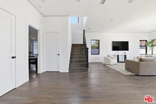 a bedroom with two beds and painting on the wall