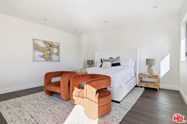 a living room with a large window and furniture